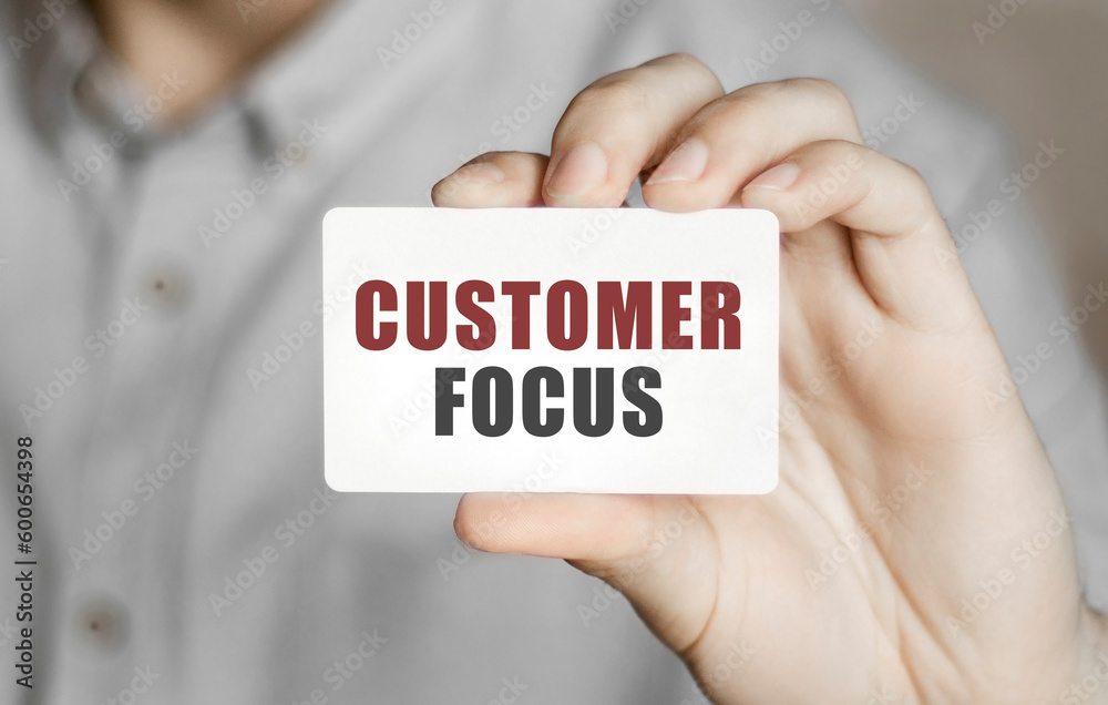 Card with text Customer focus in a man's hand Card with text Customer focus in a man's hand