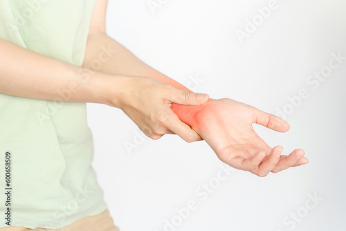 A woman holding her wrist due to an injury or rheumatoid arthritis. © Oporty786