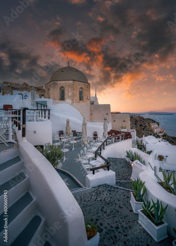 Paradise found in Santorini! This iconic image showcases the island's stunning blue domes, white houses, rugged caldera, and endless sea. © Evgeni