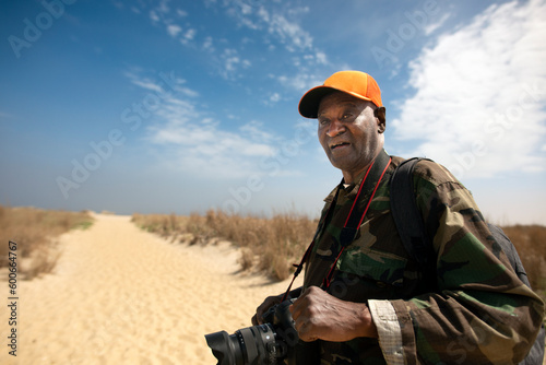 Senior retiree photographing nature at the beach photo