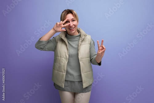 positive 30 year old blonde young woman with joy emotions on studio background