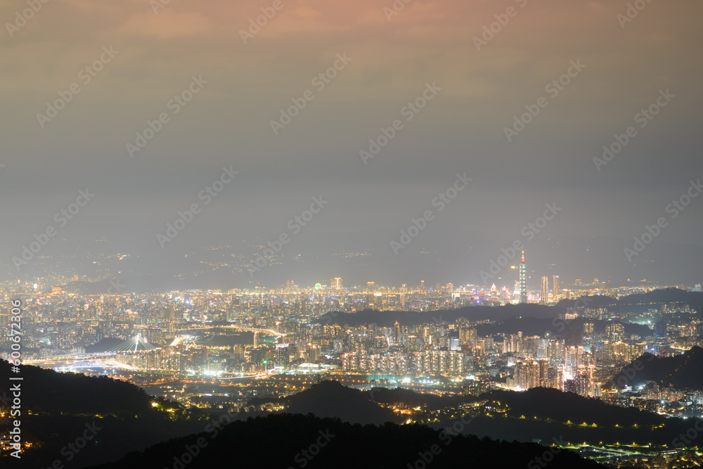 A dark night with bright lights of the city. The night view of Taipei City overlooked from Nangang Nine-Five Peak.