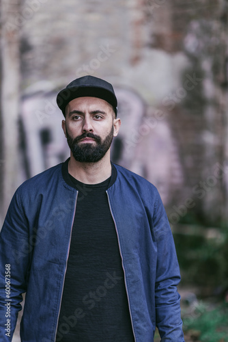 young bearded man posing on the street