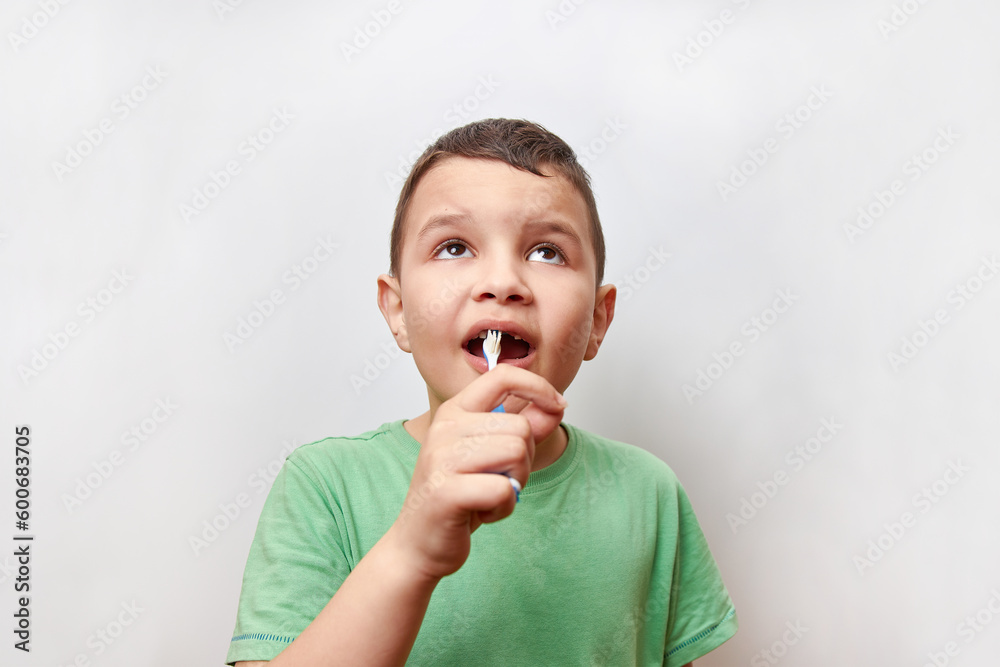 A boy with missing baby teeth uses a toothbrush. Baby teeth care. A boy with missing baby teeth uses a toothbrush. Baby teeth care.