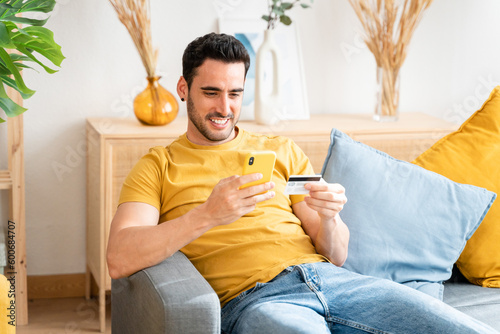 Young man with mobile phone checking his bank statement.
