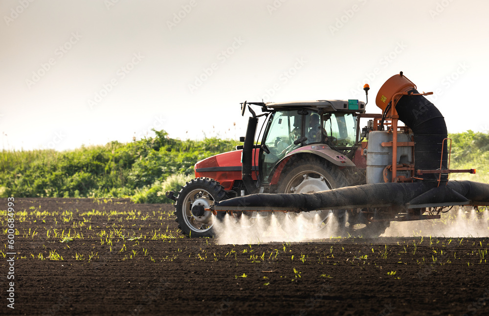 Fototapeta premium Farmer preparing his field in a tractor
