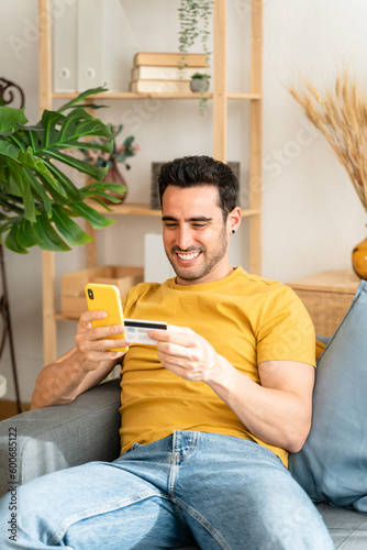 Young man with mobile phone checking his bank statement.