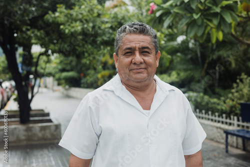 latin senior man portrait looking at camera outdoors in the street in Mexico city, hispanic adult people