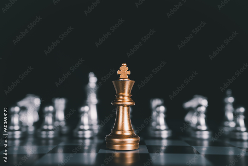 Golden King chess standing in front of other chess,strategy,teamwork, management or leadership concept. Golden King chess standing in front of other chess,strategy,teamwork, management or leadership concept.
