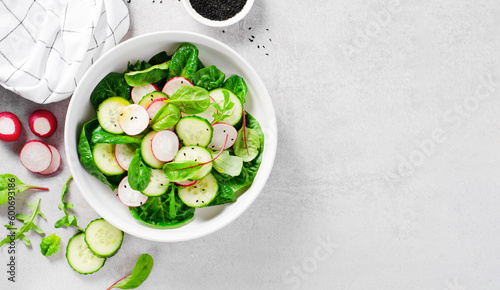 Fresh Salad with Radish, Cucumber and Lettuce on Bright Background, Healthy Vegetarian Food