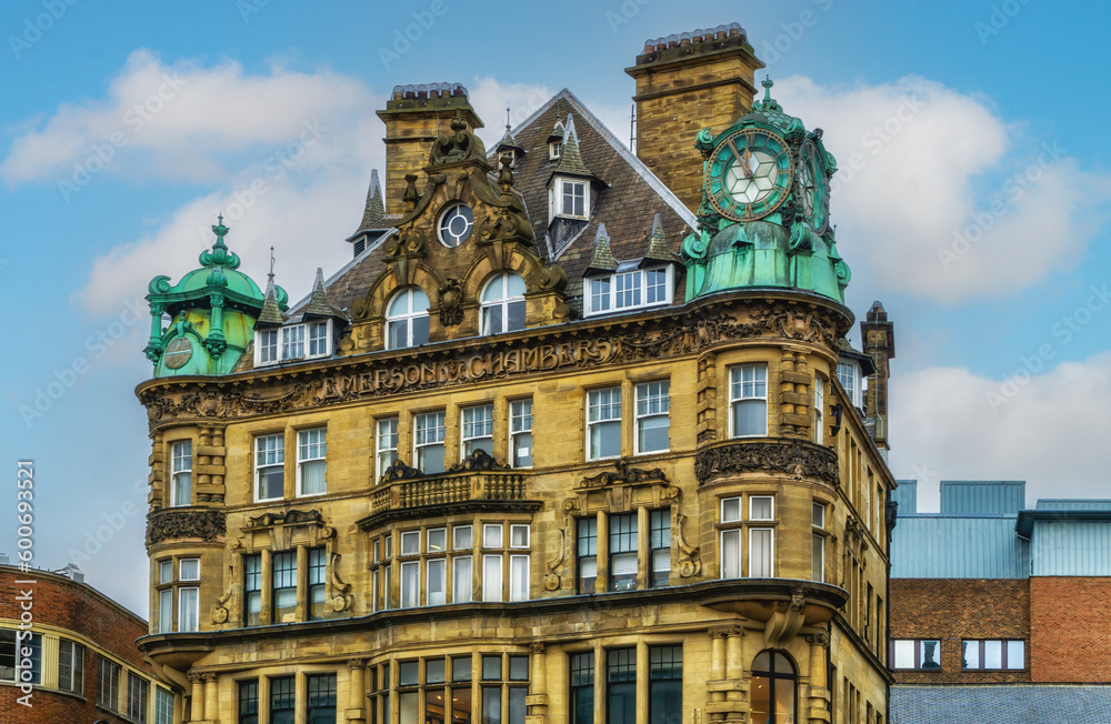 Fototapeta premium Emerson Chambers building in Newcastle City Centre featuring a copper enclosed clock on top.