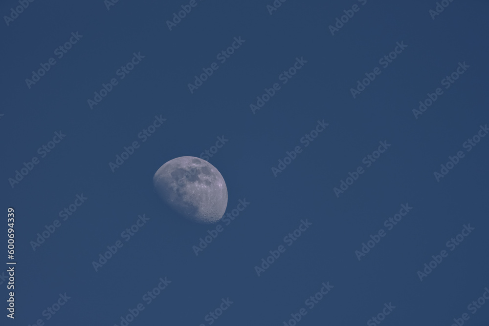 MOON - Earth satellite on the background of blue sky
