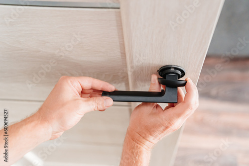 The master repairs or installs the door handle on the interior door.