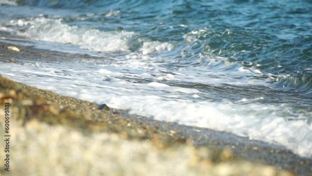 Small sea wave, Blurred Soft foamy waves washing golden pebbled beach on sunset. Ocean Waves On Beach. Nobody. Holiday recreation concept. Abstract nautical summer ocean sunset nature background. Small sea wave, Blurred Soft foamy waves washing golden pebbled beach on sunset. Ocean Waves On Beach. Nobody. Holiday recreation concept. Abstract nautical summer ocean sunset nature background.