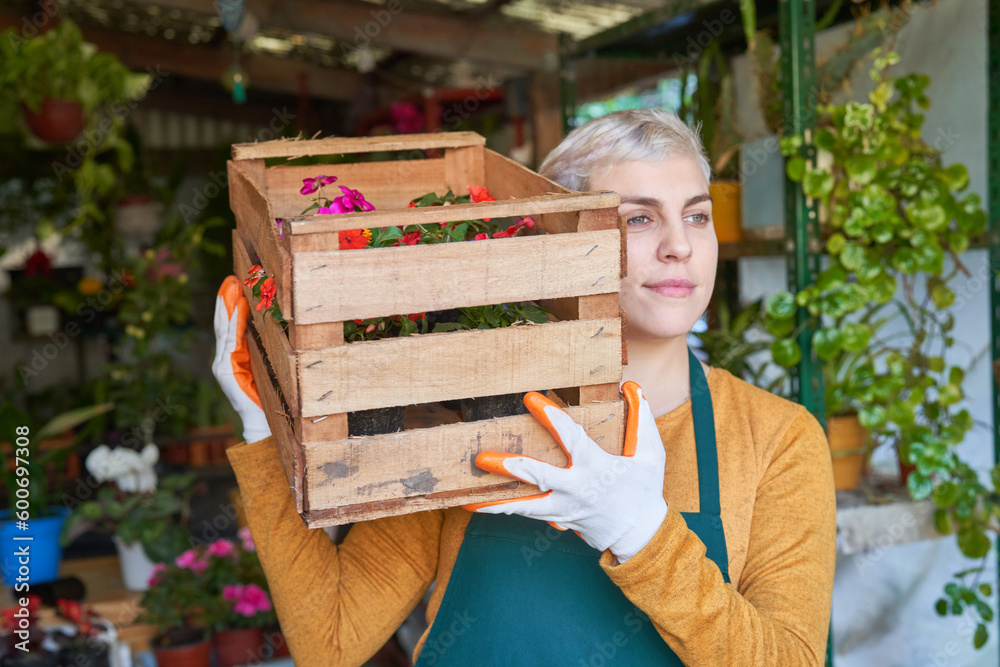 Florist carries a box of flowers for a delivery Stock Photo | Adobe Stock