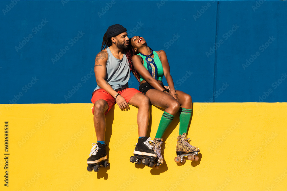 Cheerful couple with roller skating outside. Fun sexy boyfriend and girlfriend enjoy in sunny day.