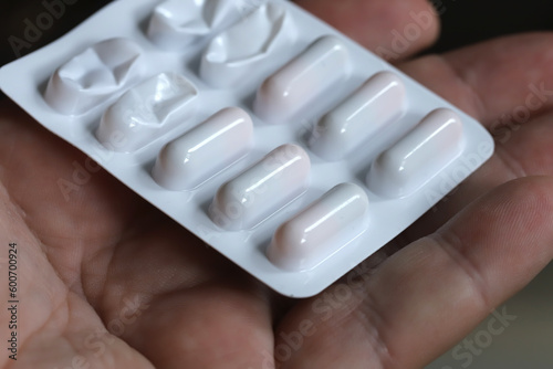 Hand holding pills close up