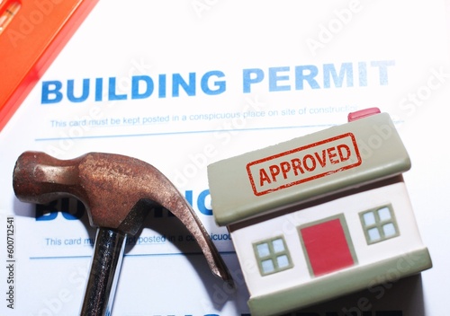 Building Permit concept with “approved” text on a residential home .