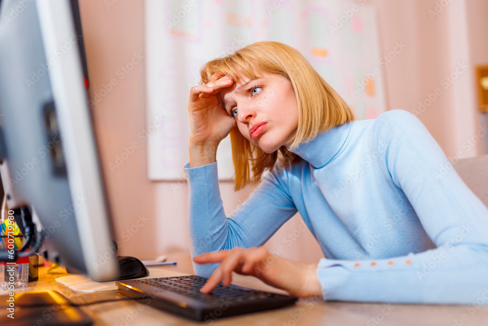 Woman exhausted and stressed out while working in an office