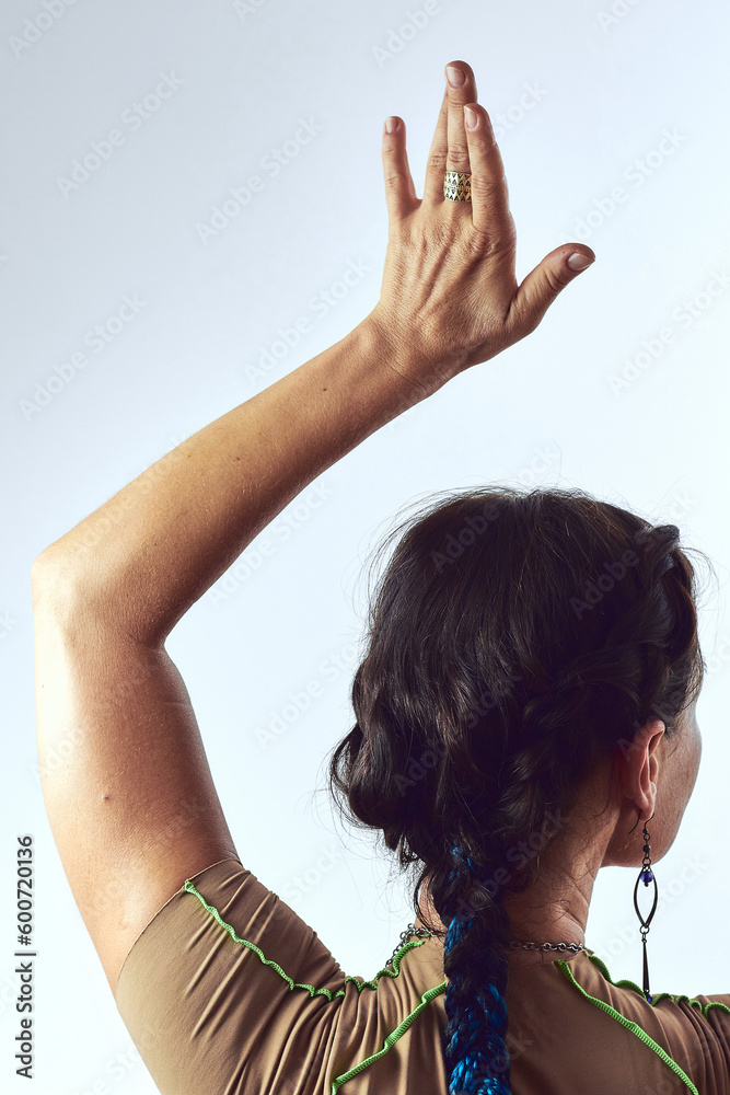Naklejka premium Back view portrait of middle aged yogi woman with brown hair practicing yoga at studio