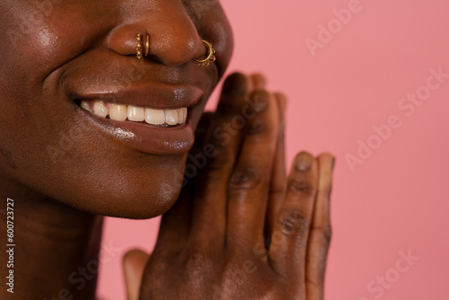 Close-up of smiling woman with nose piercings