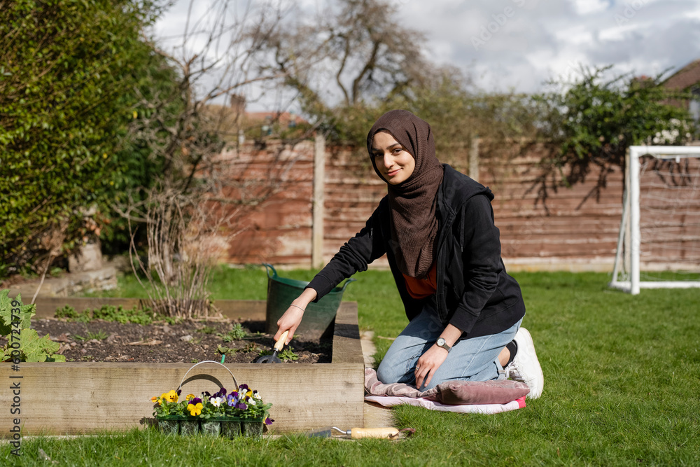 Woman wearing hijab working in garden Woman wearing hijab working in garden