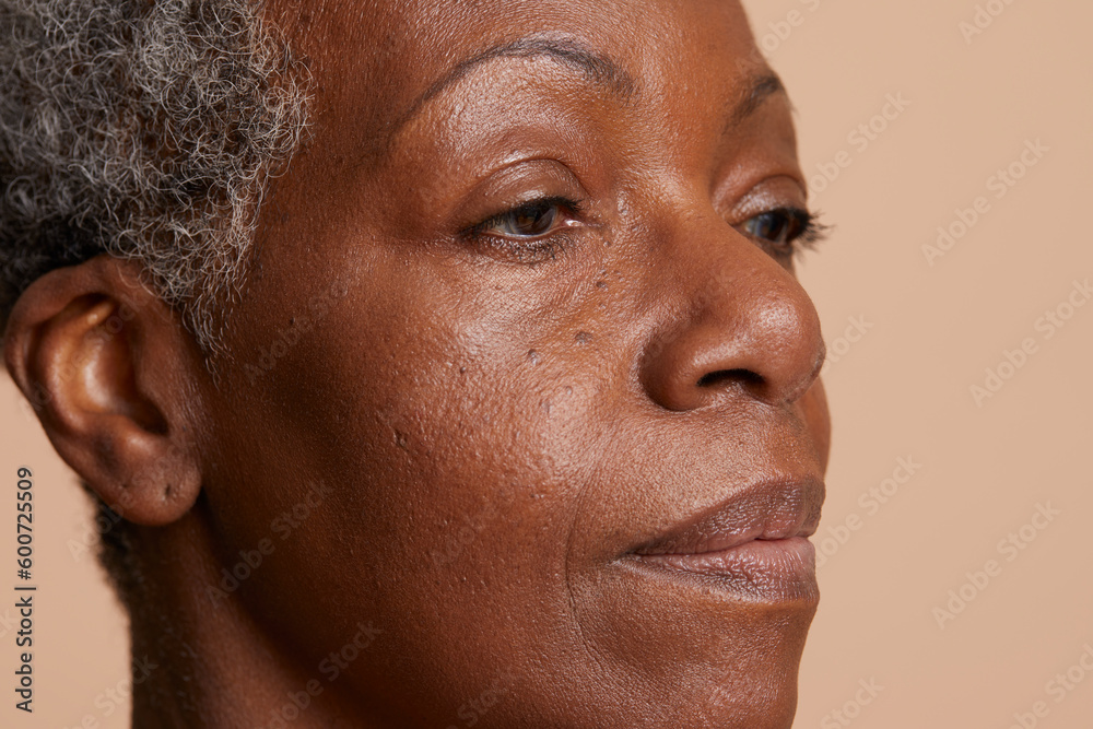 Portrait of senior woman against beige background Portrait of senior woman against beige background