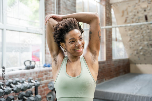 Woman stretching arms in gym before training Free Download Woman stretching arms in gym before training - GFXLoad