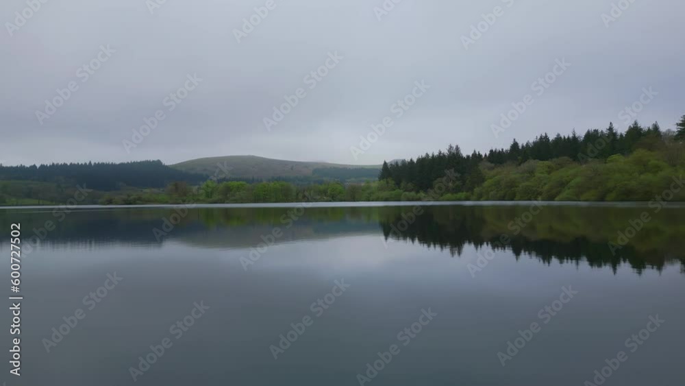 Fast drone above lake during cloudy day in dartmoor, england Fast drone above lake during cloudy day in dartmoor, england