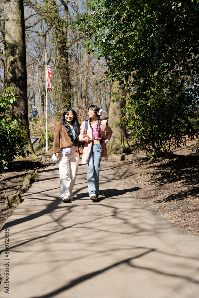 Young female friends walking in park Young female friends walking in park
