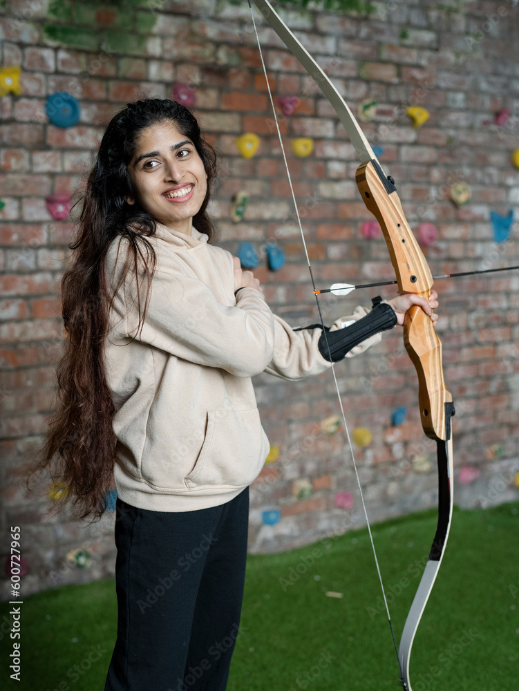Smiling young woman at archery training Smiling young woman at archery training