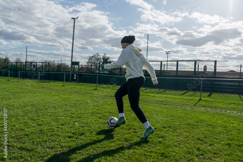 Young woman playing soccer outdoors photo