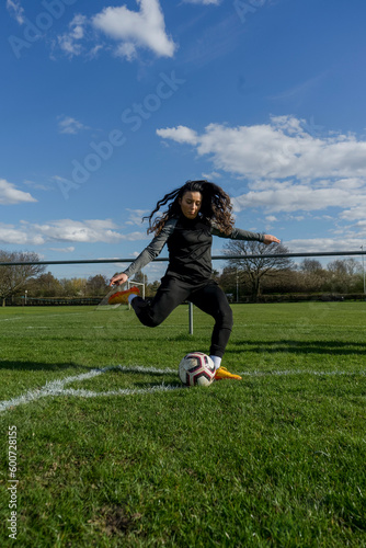 Young woman taking corner kick
