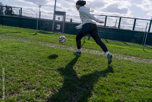 Young woman playing soccer outdoors photo