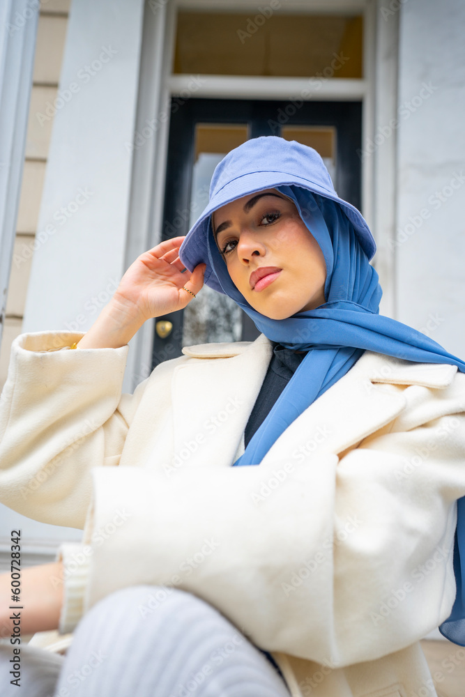 Young woman wearing hijab and bucket hat Young woman wearing hijab and bucket hat