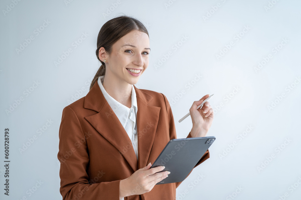 onfident businesswoman holding tablet and smiling at the camera, on white background. onfident businesswoman holding tablet and smiling at the camera, on white background.