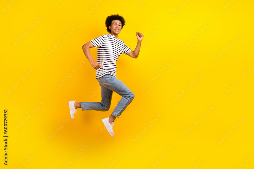Full length size photo of running fast speed energetic guy hurry up advertisement casual clothes sale isolated on yellow color background