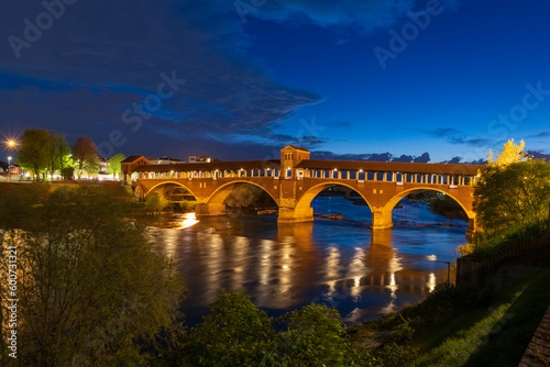 Ponte Coperto (covered bridge) over Ticino river in Pavia at blue hour, Lombardy, italy.