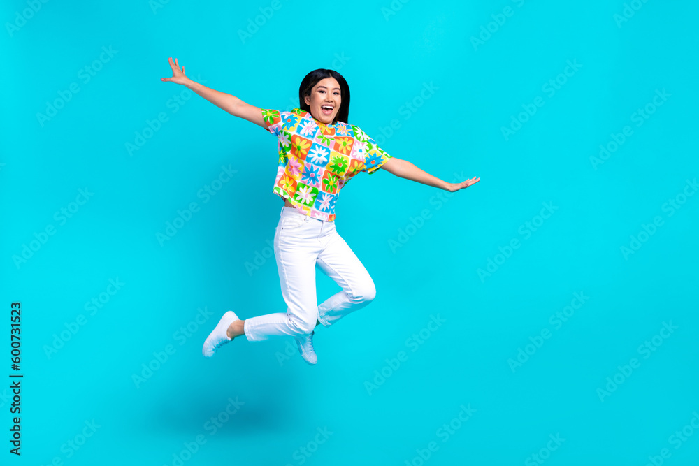 Full body photo picture of flying crazy jumping trampoline arms wings plane freedom korean funky lady isolated on blue color background