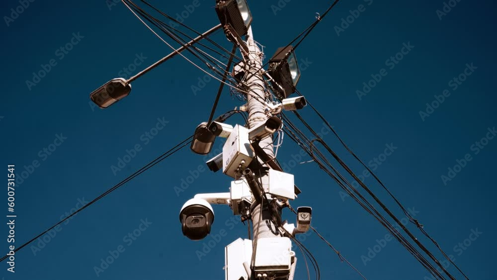 Many CCTV cameras are installed to ensure people's safety. Against the background of a bright sky. Concept of modern technologies, facial recognition, no privacy. Many CCTV cameras are installed to ensure people's safety. Against the background of a bright sky. Concept of modern technologies, facial recognition, no privacy.