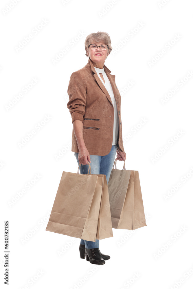 Full length portrait of a Senior woman walking with shopping bags Full length portrait of a Senior woman walking with shopping bags