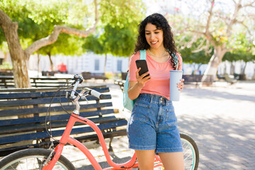 Beautiful woman taking a bike stroll in the park looking happy