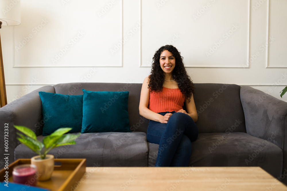 Happy young woman smiling in the living room Happy young woman smiling in the living room