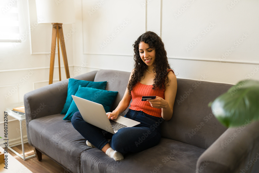 Cheerful woman having a video call on the laptop in the living room Cheerful woman having a video call on the laptop in the living room