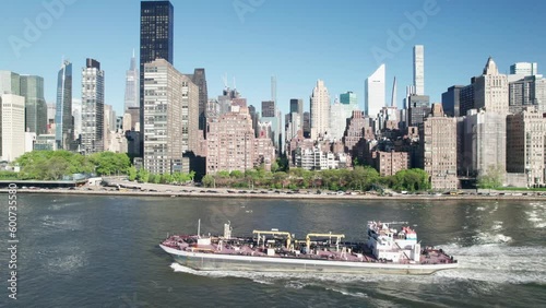 Working ship in NYC, tracking shot with city skyline in background.