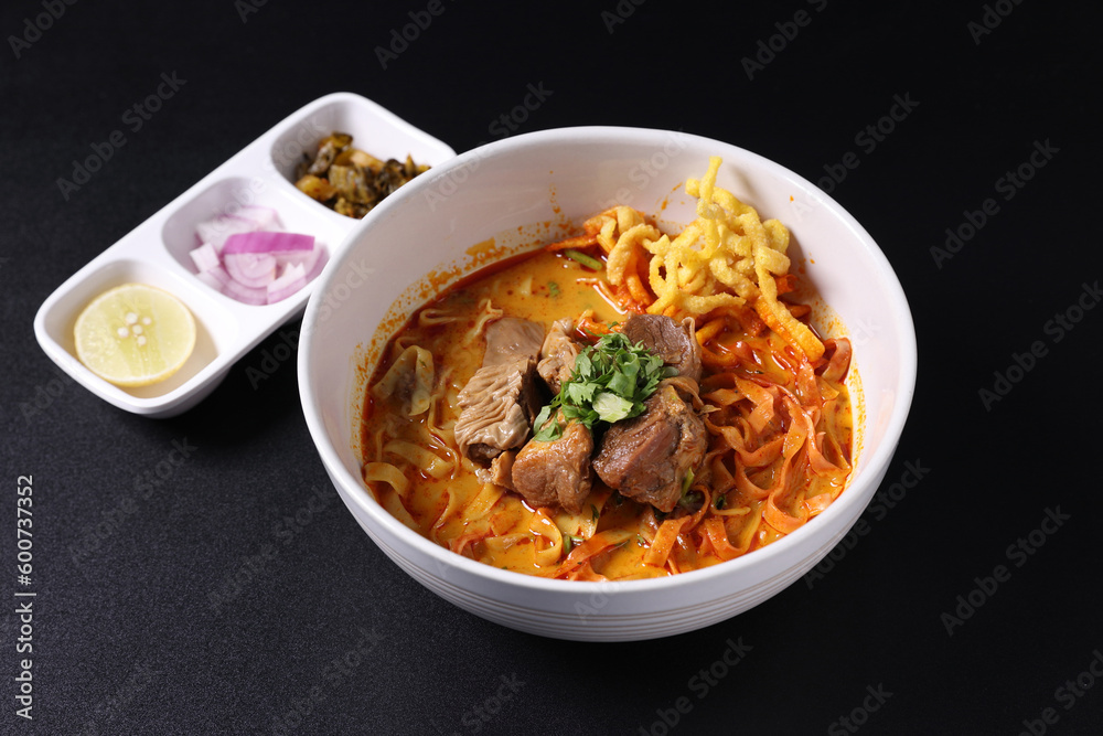 Khao Soi Thai Curry soup isolated in black background