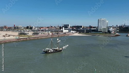 Sailing Boat at The Port of Scheveningen, Netherlands, Sunny Day, Aerial Wide Circling Shot photo