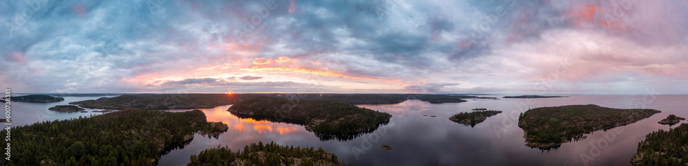 Sunrise in the wild. Dawn. Nature of Karelia. Pine on the shore of Lake Ladoga. Travel to Russia. Republic of Karelia. Islands. Northern nature. The sun above the water. photographed from heights