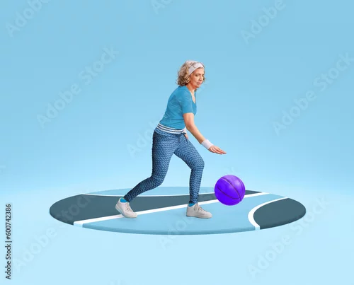 Obraz Middle-aged, senior woman in comfortable, stylish sportswear training, playing with basketball ball, dribbling against blue background. Concept of sportive lifestyle, action, motion. Copy space for ad