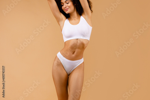 Fitness and wellness. Fit lady showing her toned physique, promoting the benefits of exercise and balanced lifestyle